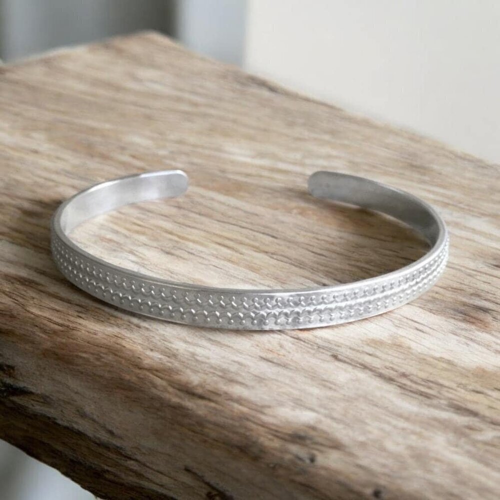 Brushed sterling silver scalloped open cuff bangle bracelet with satin finish.